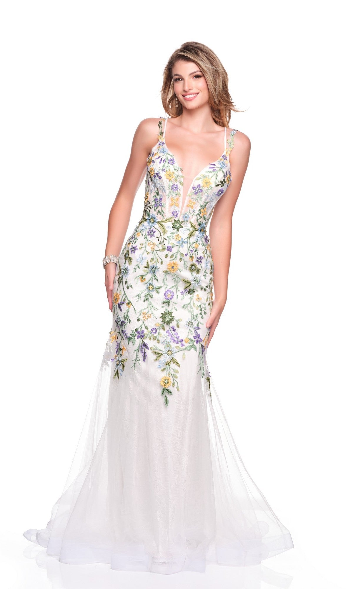 A woman models the Dave and Johnny 12447 long prom dress—a sleeveless, floor-length white gown with colorful floral embroidery—against a plain white background.